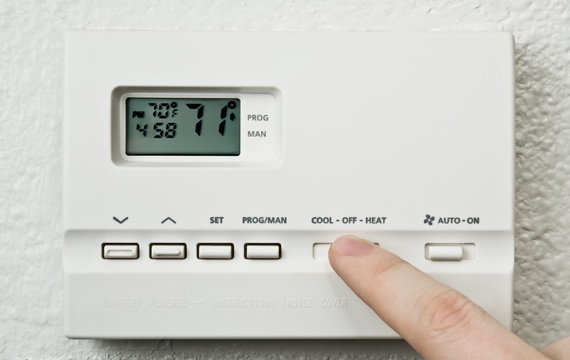 pointing to thermostat.